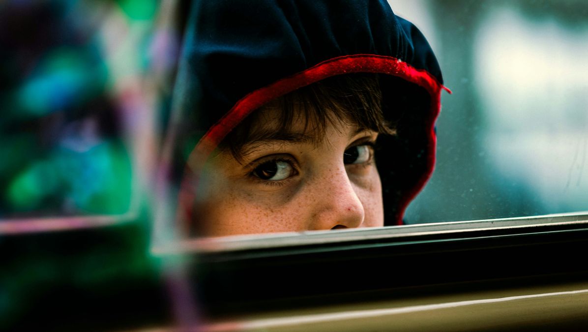 Child in car looking slightly sick