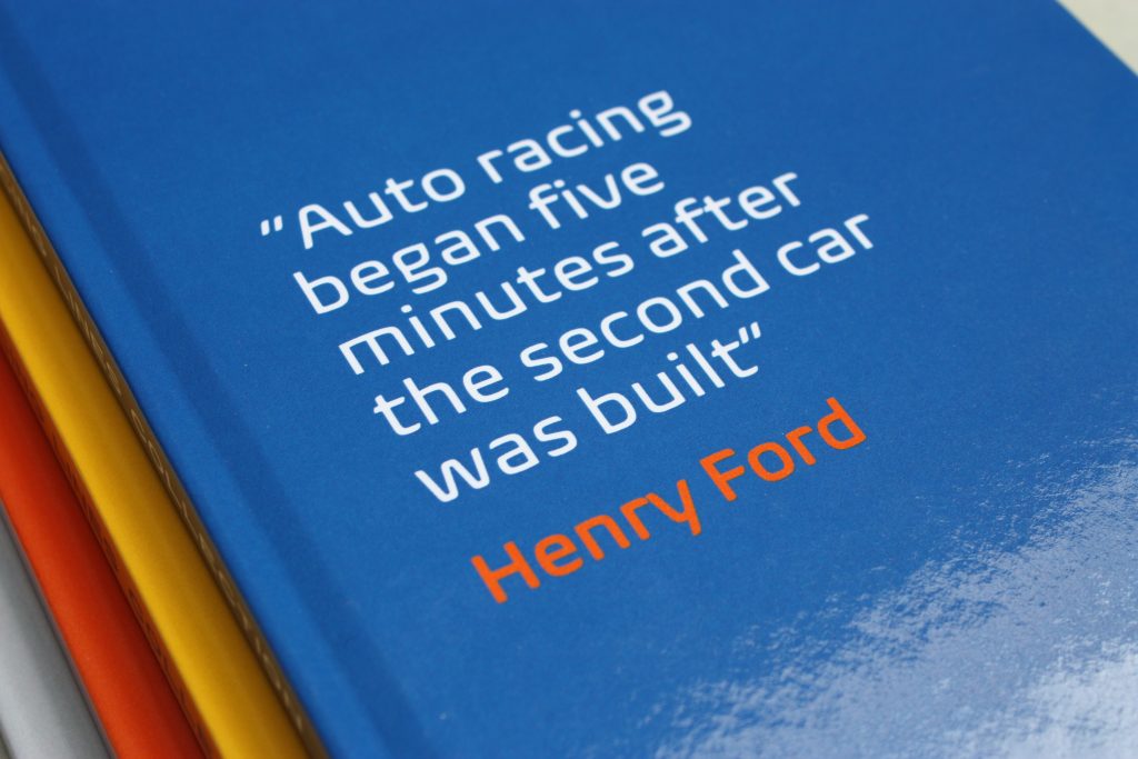 A close up view of a jotter pad with a Henry Ford quote on the cover.
